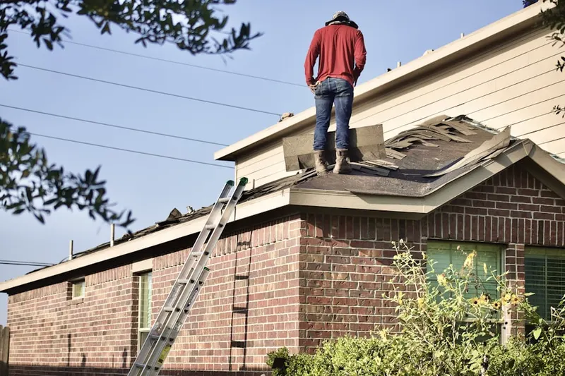 Professional roofer working on a residential roof in Lander Crossing
